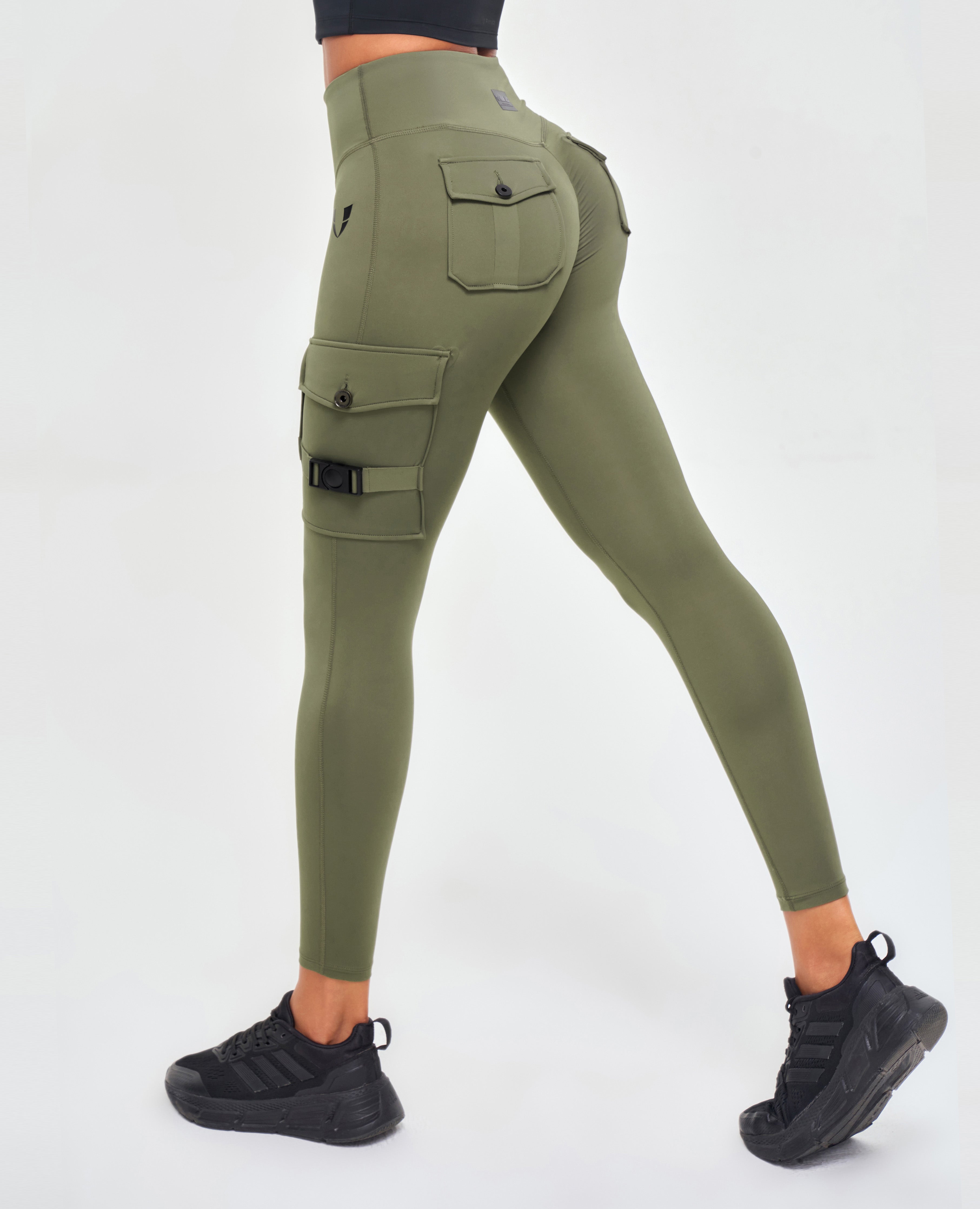 FIRM ABS olive green pocket leggings for fitness with multiple side and back pockets worn with black sneakers