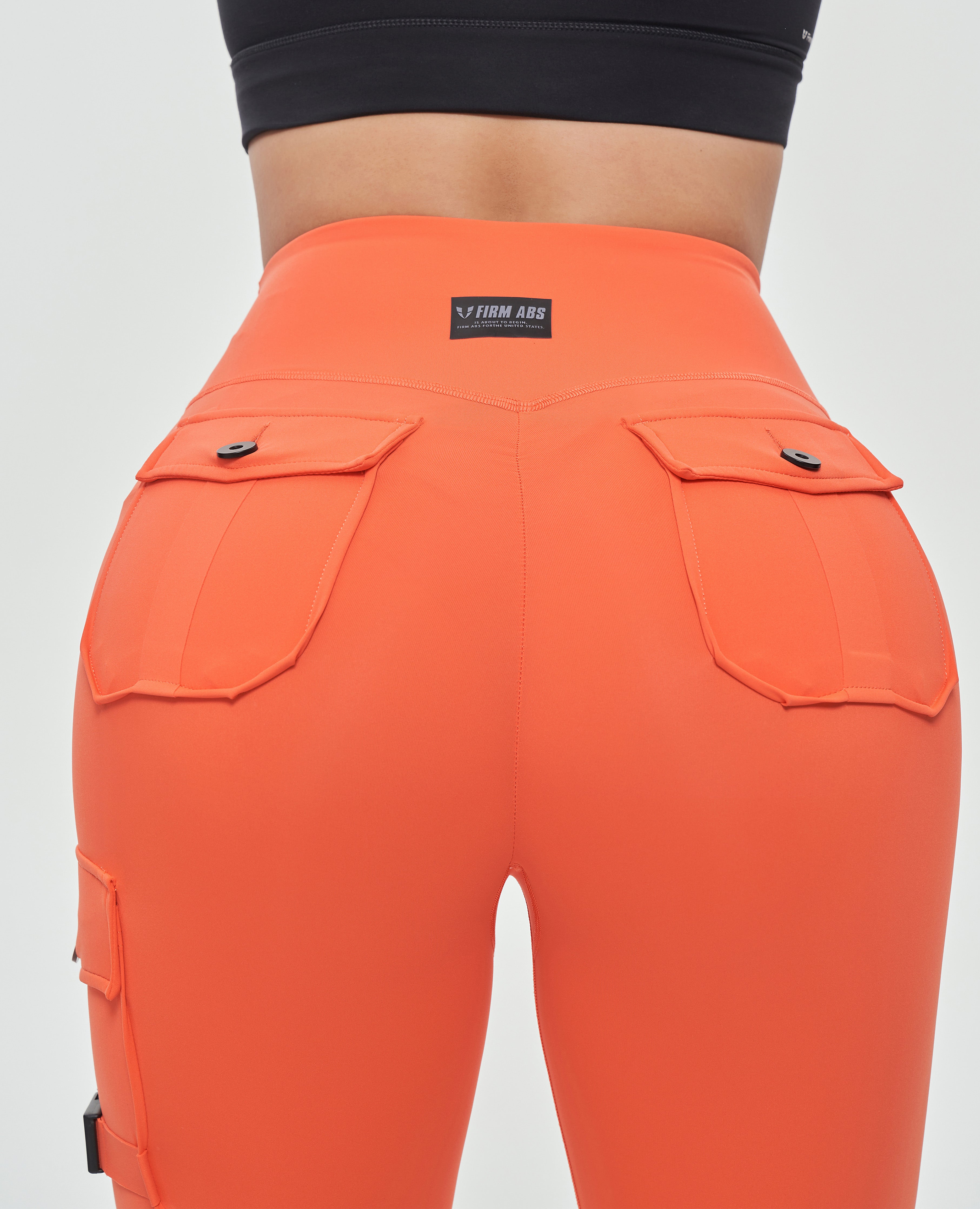 FIRM ABS durable leggings for outdoor activities in bright orange with back pockets and high waist