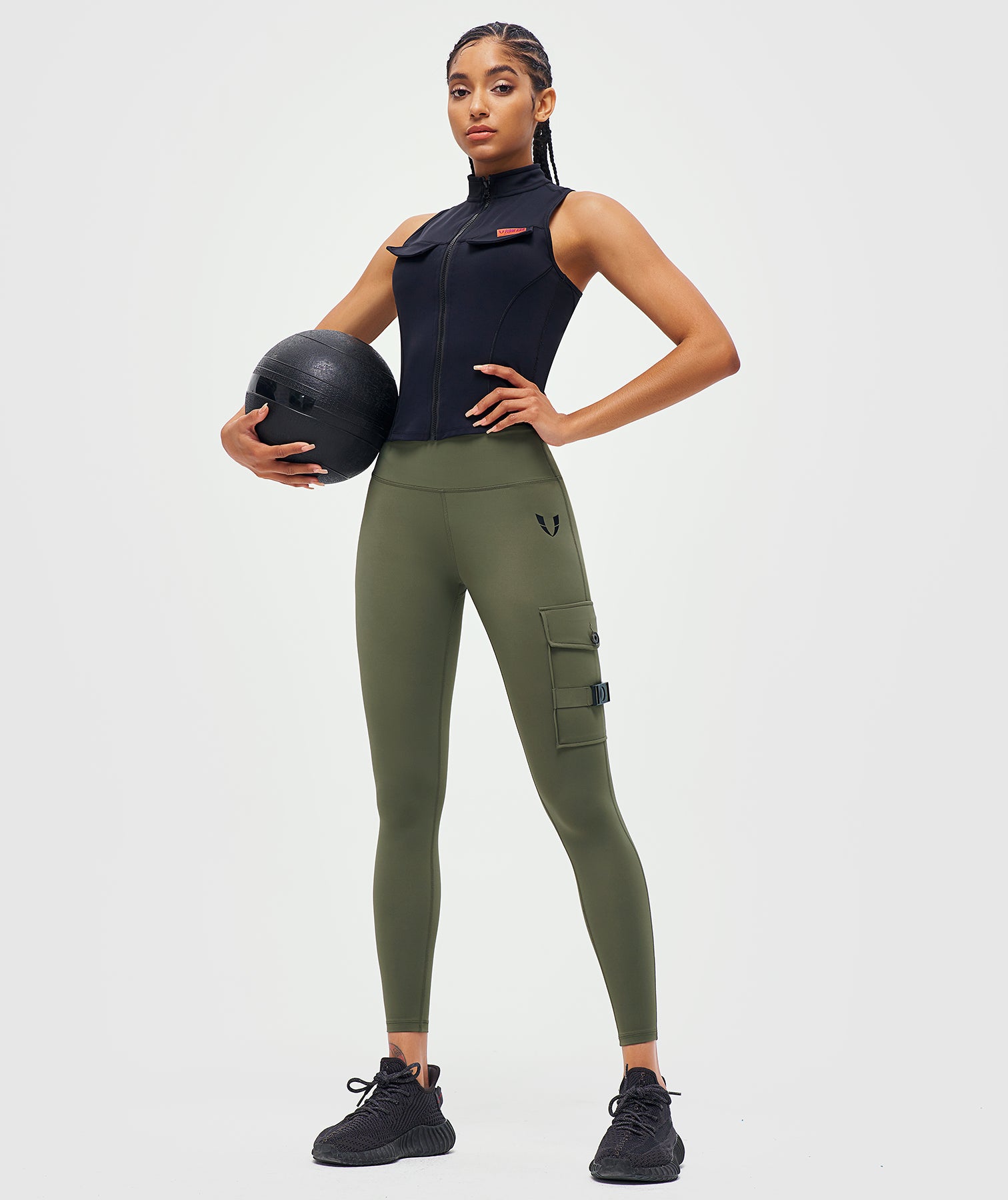 FIRM ABS sleeveless black zipper tank top styled as a stylish workout top for women