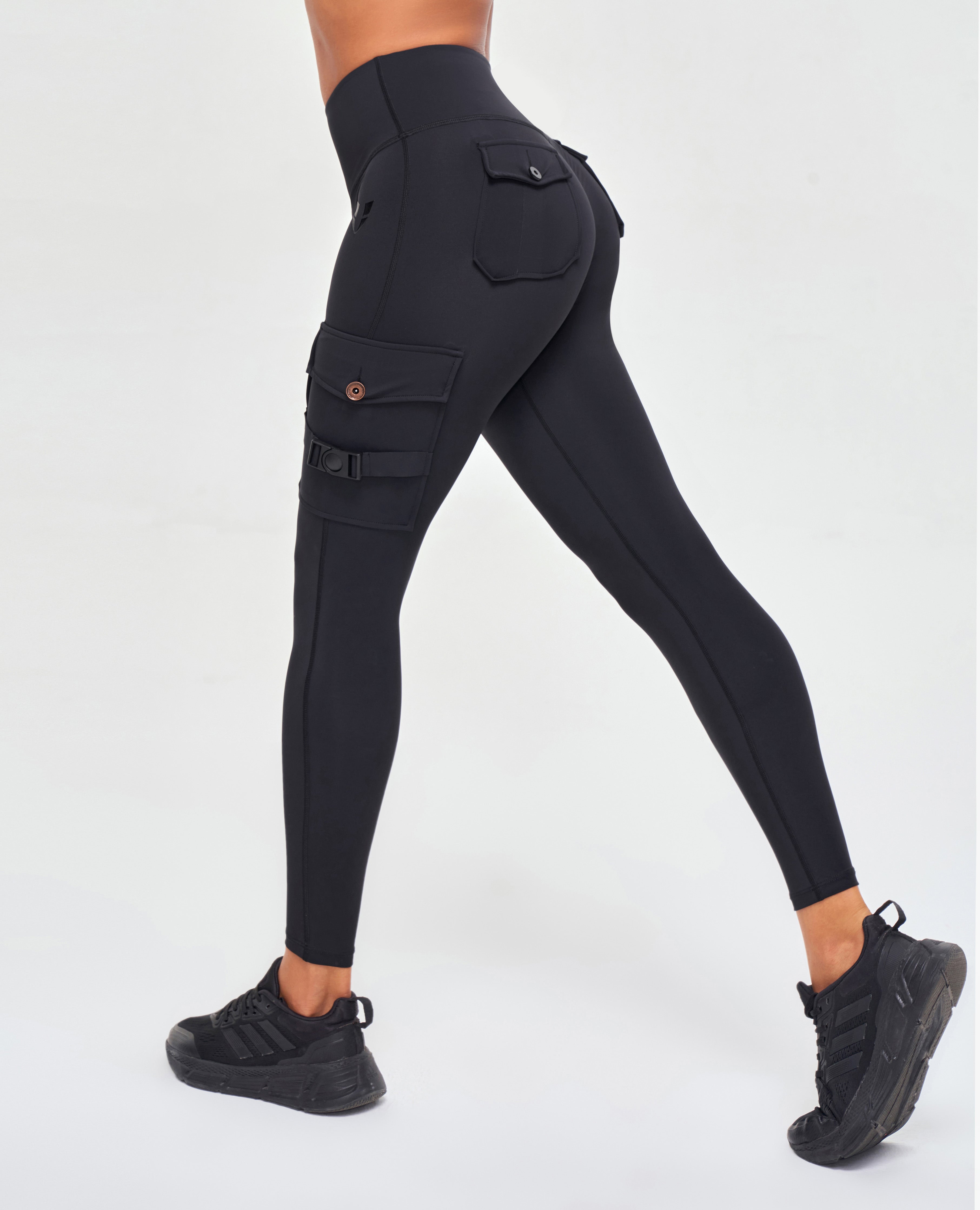 FIRM ABS high-waisted cargo leggings in black with side pockets and button details