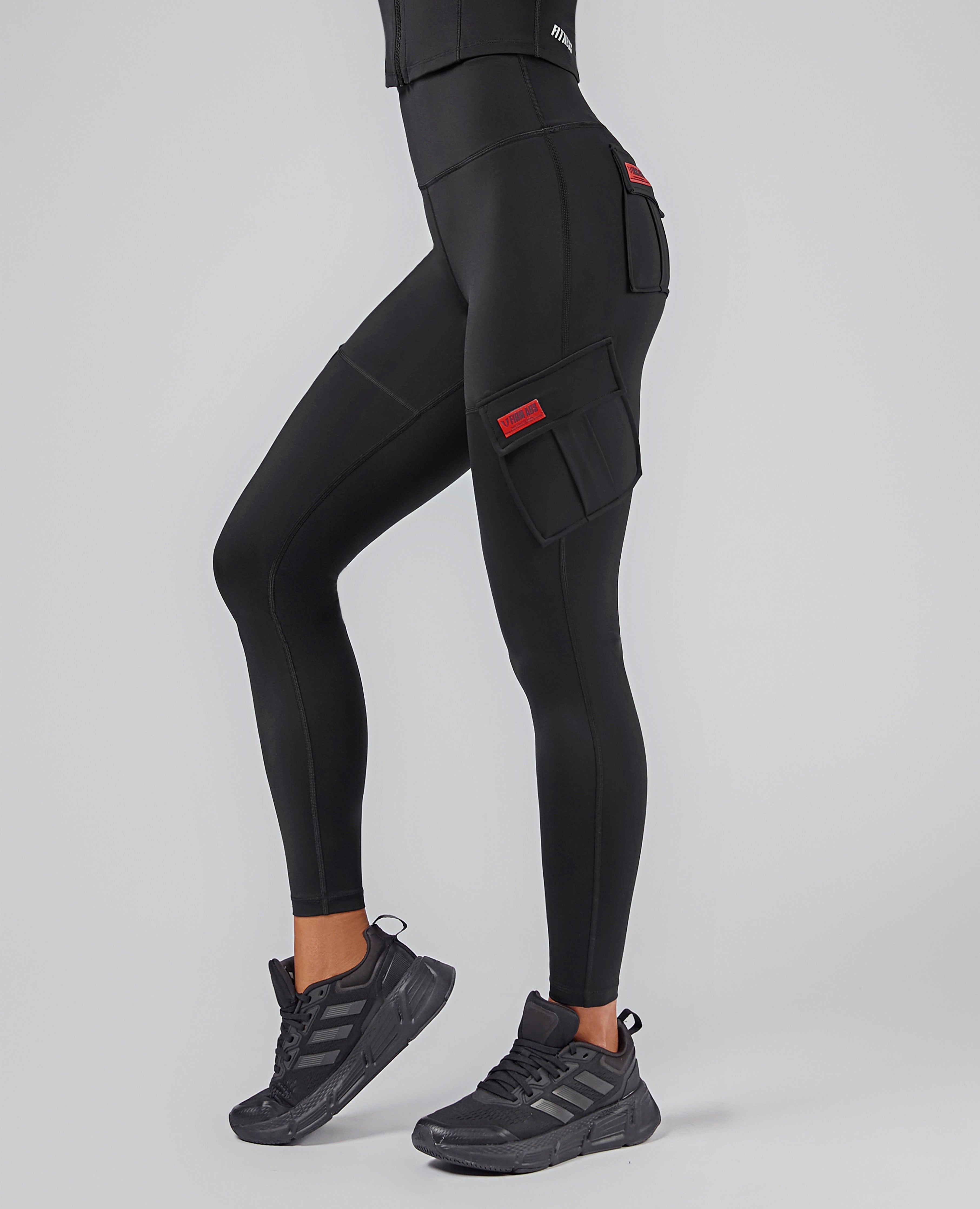 FIRM ABS high-waisted cargo leggings in black with side pockets and fitted design