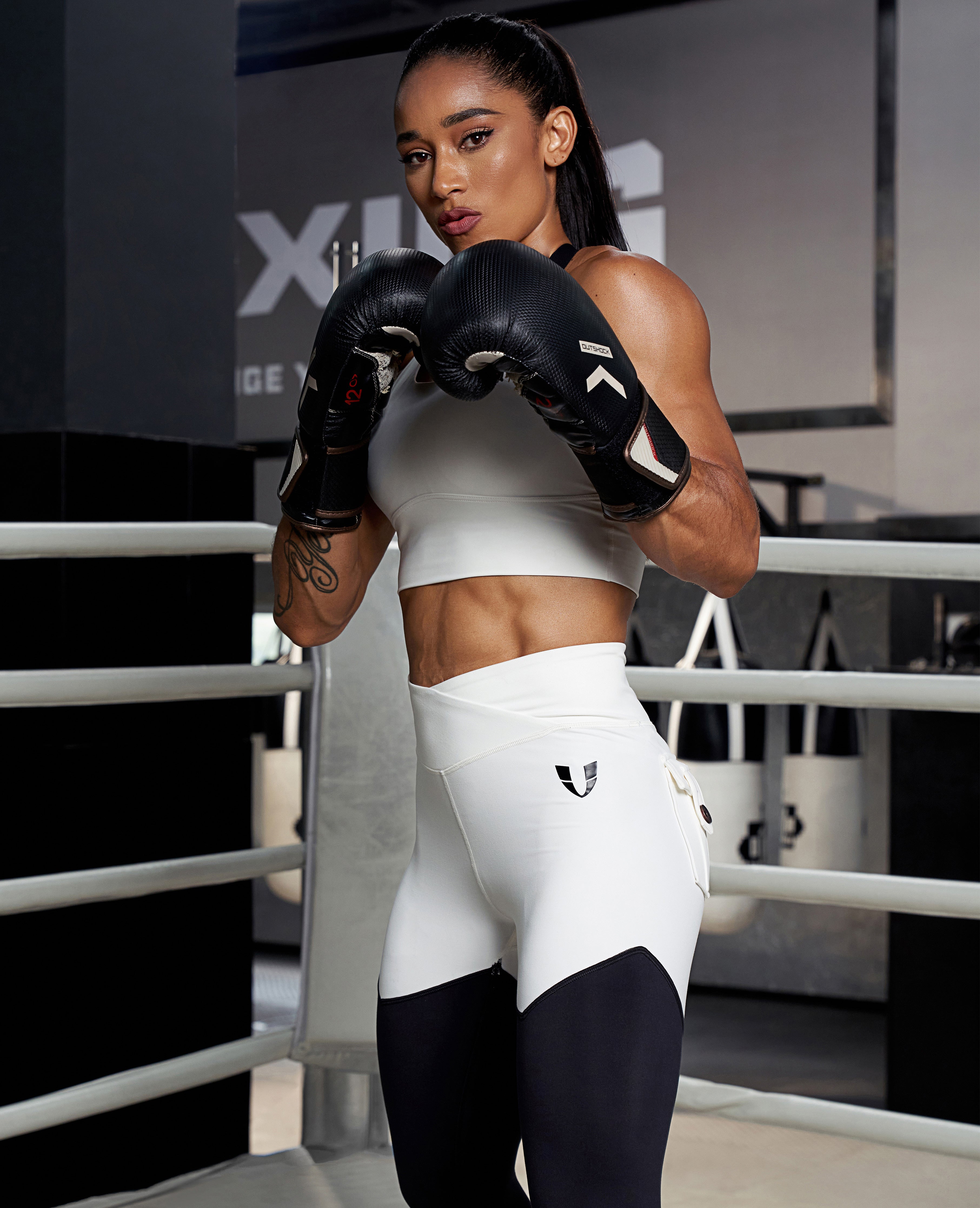 FIRM ABS stylish fitness leggings in white and black worn by woman boxing in gym