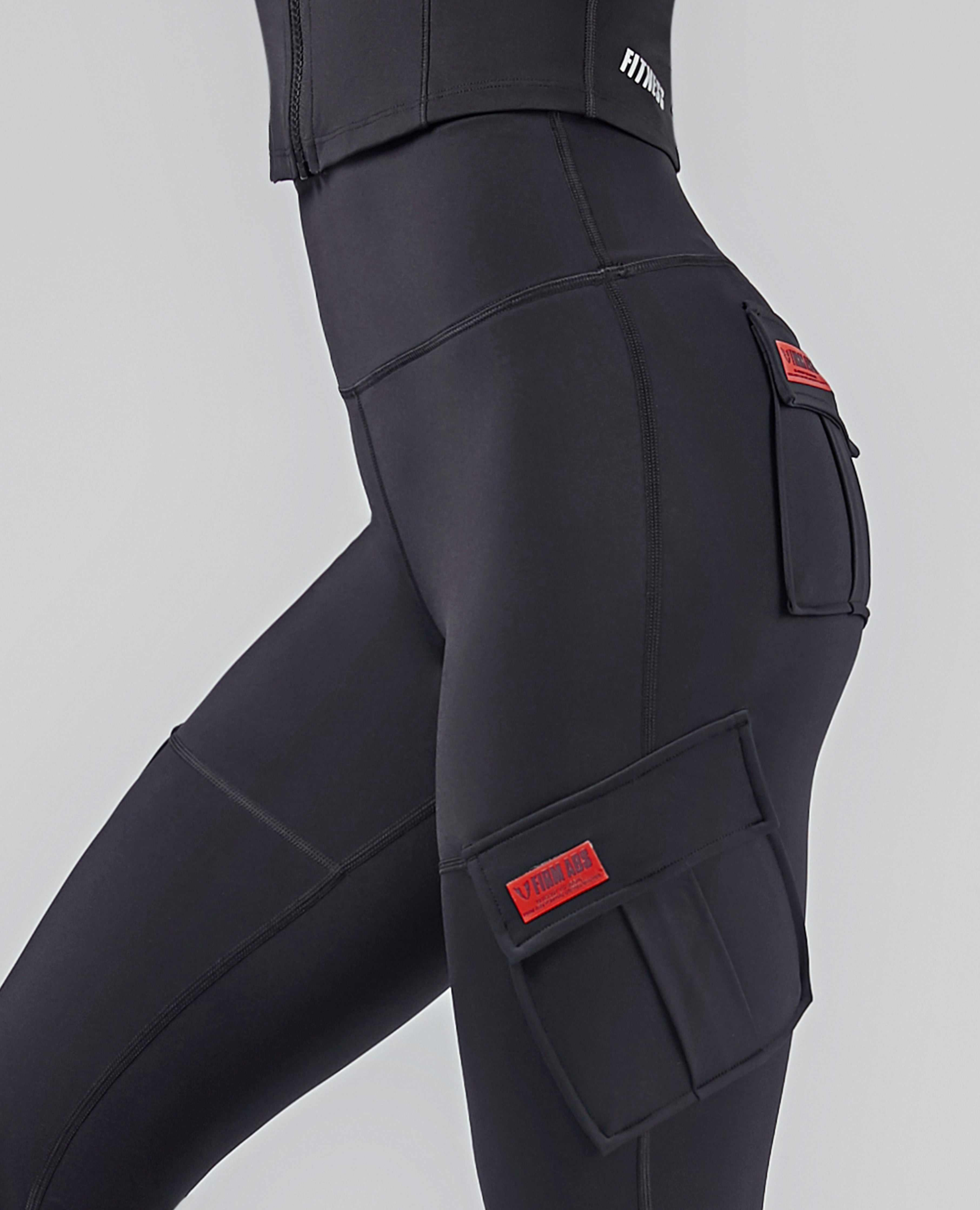 FIRM ABS black high-waisted cargo leggings with side pockets and red logo patches