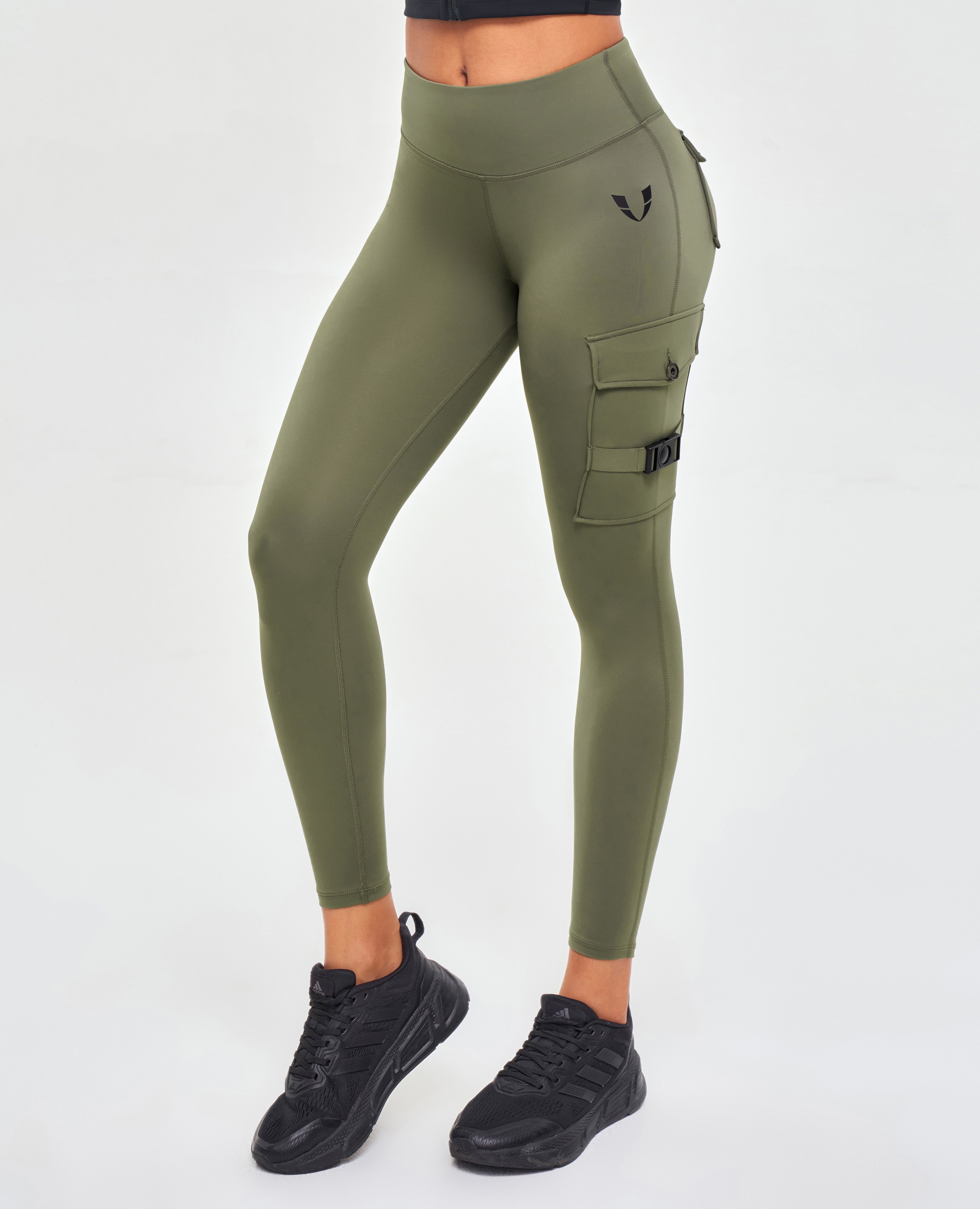 FIRM ABS olive green pocket leggings for fitness with side cargo pockets worn with black sneakers
