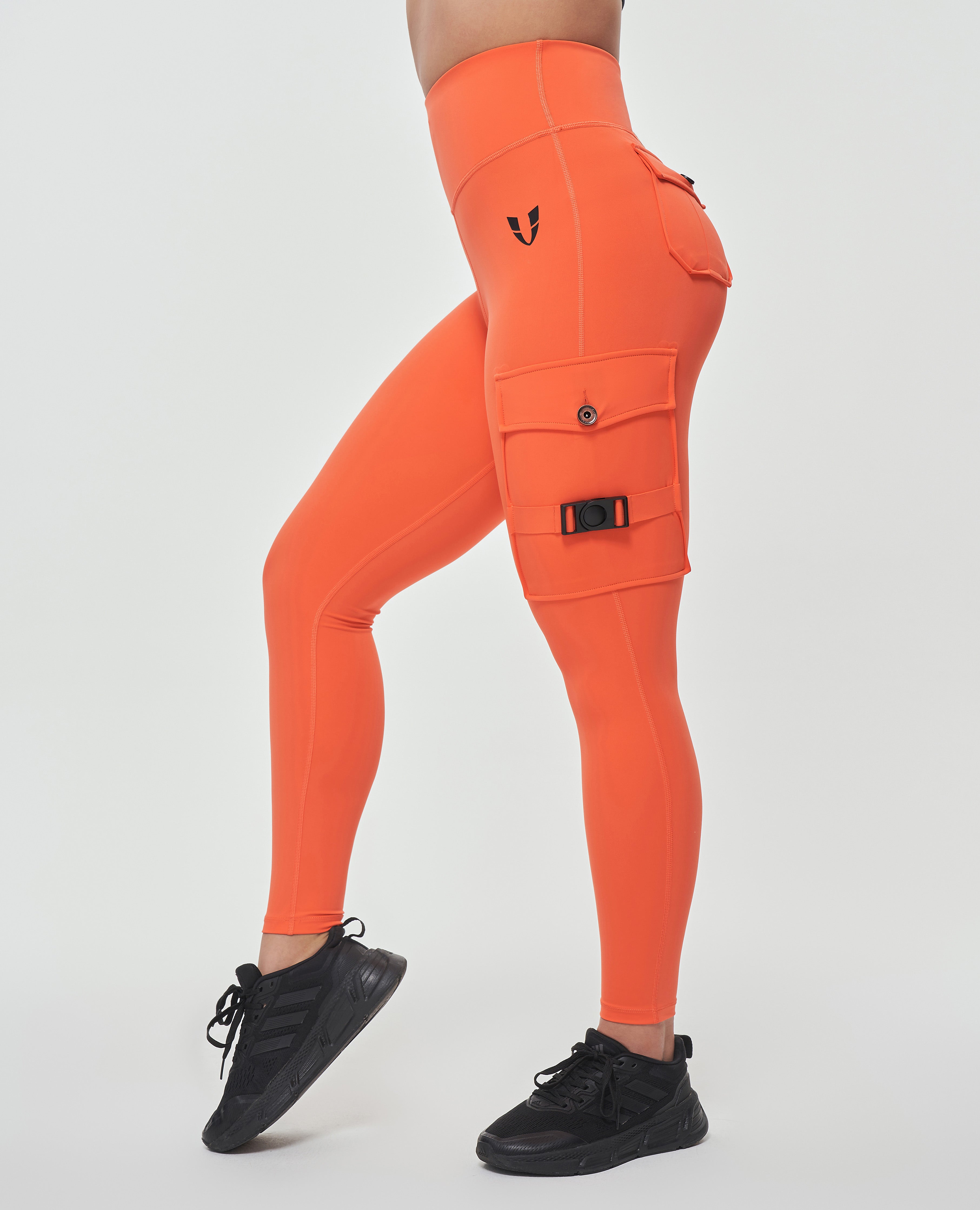 FIRM ABS orange leggings with side pockets designed as durable leggings for outdoor activities